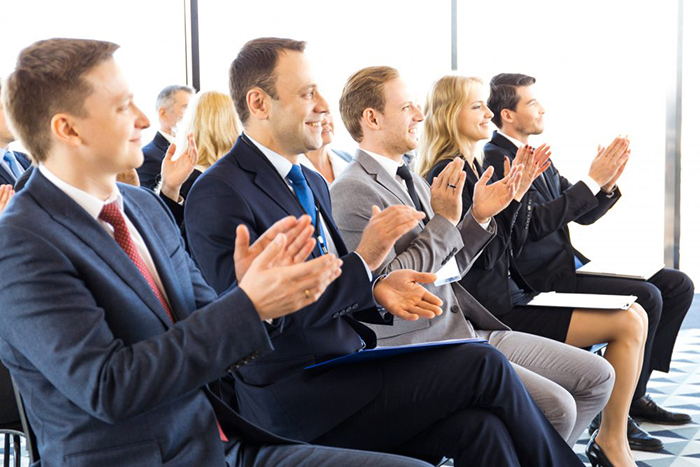 Business-audience-applaud-at-training-824910176_4976x3318-e1544746024520